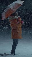 A Person Standing in Snowy Weather While Holding an Umbrella for Protection and Warmth video