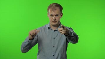 Guy showing loser gesture, pointing finger to camera, sarcastic smile, blaming for failure, lost job video