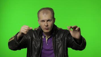 Man showing advertising area. Looking shocked, pointing with hands for your promotional text, logo video