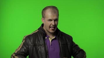 Rocker man showing rock and roll sign, devil horns gesture, looking with crazy expression video