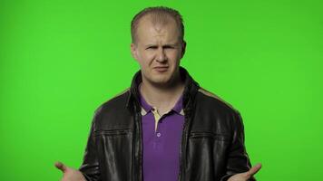 Don't want to listen. Rocker man covering ears with arms not to hear talk, avoiding problems video