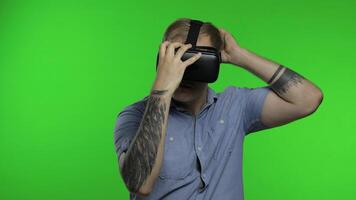 Man using VR app helmet to play simulation game, drawing. Guy watching virtual reality 3d video