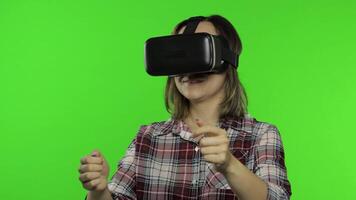 Woman using VR headset helmet to play racing game. Watching virtual reality 3d 360 . Chroma key video