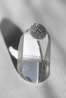Silver round pendant with unique geometric grooved pattern. Handcraft precious item. photo