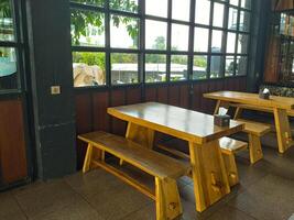 Cozy Wooden Benches in a Bright Indoor Cafe Setting photo
