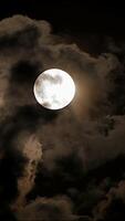 A Mysterious Night Sky adorned with a Full Moon accompanied by Dramatic Clouds in view video