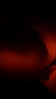 An abstract image with dark orange hues blending light and shadow for a captivating visual video