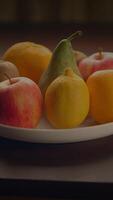 A Variety of Colorful and Fresh Fruits Arranged Beautifully in a Bowl on a Rustic Wooden Table video