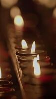 The Serene and Gentle Candle Flames Flicker Softly in a Dimly Lit Space, Creating Calm video