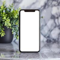 Black smartphone mockup template on marble surface. Front view photo
