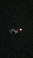 A solitary person holding a flickering flame in a dark and mysterious environment video