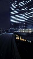 A stunning illuminated urban nightscape featuring striking modern architecture and design video