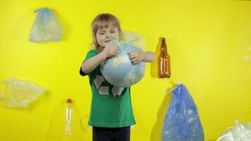 Girl activist tries to free Earth globe from plastic package. Reduce trash pollution. Save ecology video