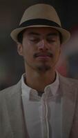 A fashionable and stylish young man is decked out in a striking hat and a classy suit video