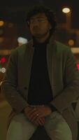 A contemplative man situated in a serene urban night setting, immersed in thought video