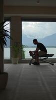 A man exercises while enjoying a scenic view of beautiful water and majestic mountains video