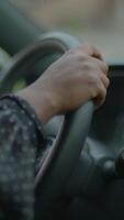 A closeup view of a hand gripping the steering wheel while driving a vehicle on the road video