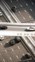 An overview of a highway with a white car in an urban setting, showcasing city life video