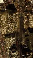 Experience the stunning aerial view of a vibrant night cityscape with glowing skyscrapers video