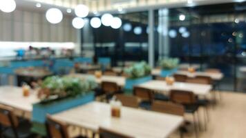 Blurry background of restaurant. Customer is waiting for food and waiters are ready to serve photo