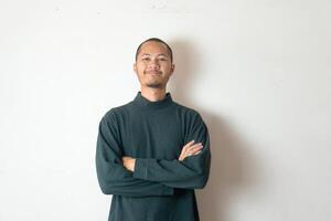 Young men wearing green sweater smiling on isolated white background photo