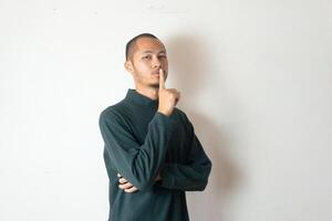 Young men wearing sweater gesturing silent on isolated white background photo