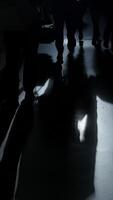 Silhouetted figures on a glossy floor create an intriguing visual contrast and artistic depth video