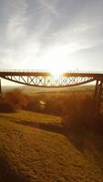A breathtaking and scenic sunset view unfolds beneath a majestic bridge, creating an video