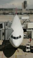 An airplane is situated at the airport terminal, facilitated by comprehensive ground services video