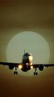 A silhouette of an airplane flies against a beautiful sunset, creating visual harmony video