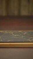 An Elegant Marble Patterned Notebook Resting Beautifully on a Wooden Table Surface video