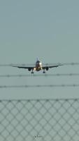 An airplane is making its landing procedure in close proximity to the airport fencing area video