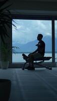 Silhouette of a Person Sitting in Contemplation with a Scenic Mountain View in the Background video