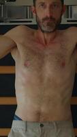 A man exercises in a gym, focusing on fitness goals and pushing his limits for better health video
