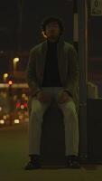 Lonely Night A Seated Figure Thoughtfully Resting in a Dimly Lit Urban Landscape at Night video