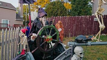 Chicago Illinois 17.10.2024 Halloween pirate and skeleton display in a spooky yard scene, The decorations include a large rat and various skeletal elements, all set against a weathered wooden fence in video