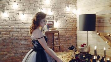 Witch at table. Portrait of woman dressed in witch style sitting by the table video