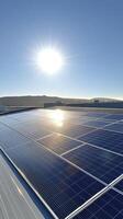 Sun shining on solar panels installed on industrial building roof photo