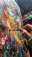 Artist painting on canvas with colorful oil paint and brush photo
