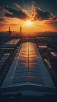 Sunset illuminating solar panels on factory roof in industrial area photo