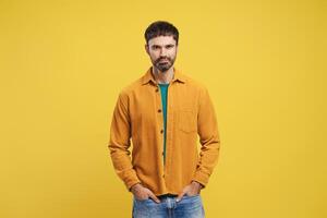 Confident, happy, bearded Hispanic man wearing stylish casual clothes, hands in pocket photo