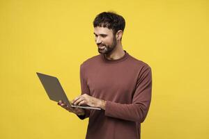 Confident bearded man, successful businessman, freelancer using laptop copywriter typing on keyboard photo