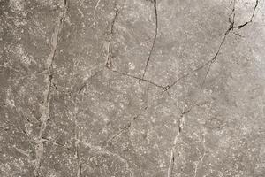 Cracked stone surface forming abstract pattern texture background photo