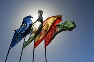 Four flags waving in the wind on a sunny day photo