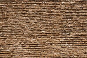 Background of old weathered red brick wall showing deterioration photo