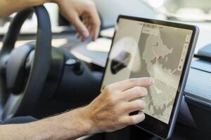Man using gps navigation system while driving car photo
