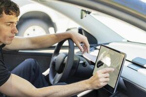 Man driving modern car using gps navigation system photo