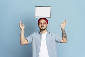 Web designer relaxing with laptop balancing on head photo