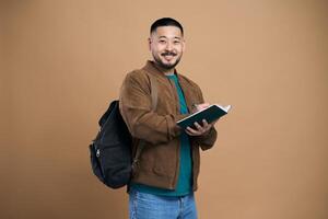 Happy student taking notes while smiling at university photo