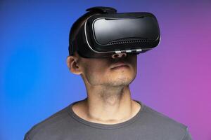 Man using virtual reality headset experiencing metaverse photo